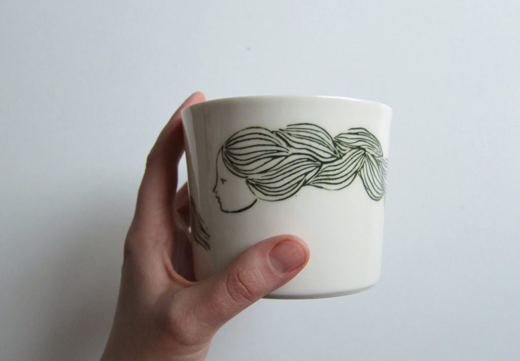 Tasse de porcelaine blanche à la main unique avec une illustration de la jeune fille aux longs cheveux, pour toutes sortes de boissons, des desserts et des collations.